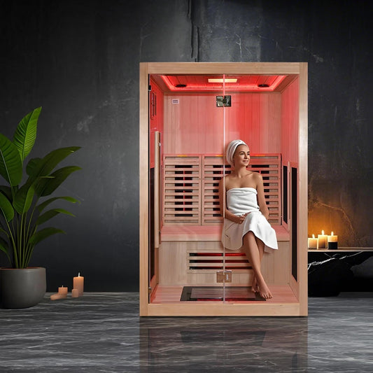 LADY USING INFRARED SAUNA INDOORS WITH GREEN PLANTS AND CANDLES 
